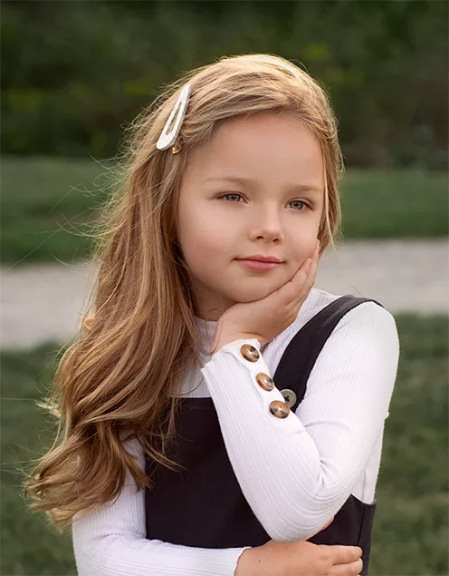 Natural outdoor portrait of a young girl during a family lifestyle photography session
