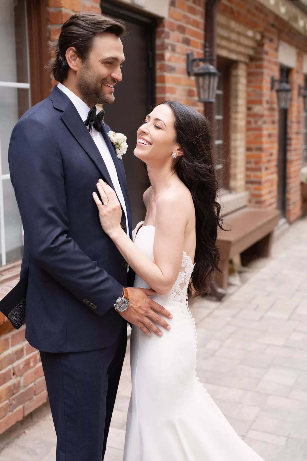Couple smiling together in wedding attire during a candid celebration portrait